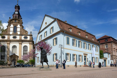 Das Hohenfeldsche Haus mit Pilgerstatue und Dreifaltigkeitskirche 